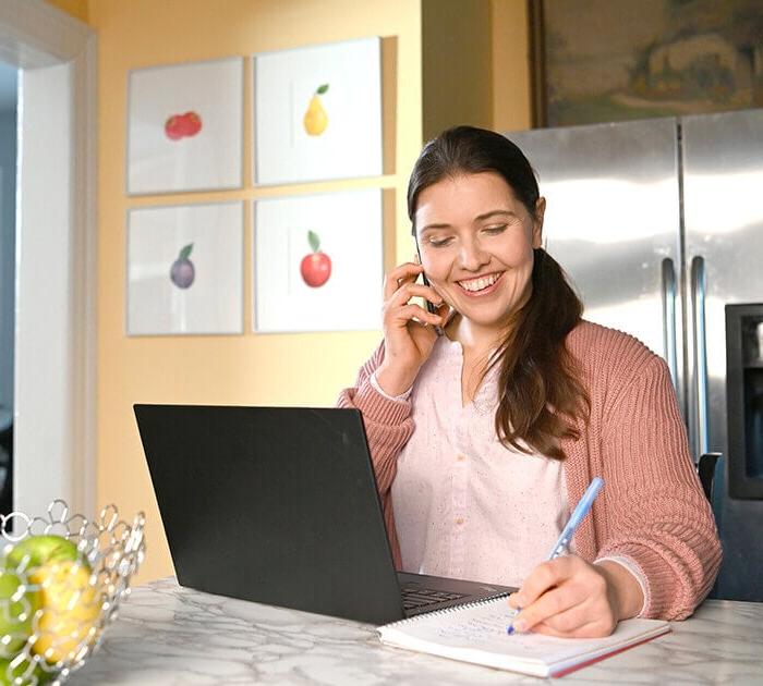 Parent speaks with online school technology support on the phone - Connections Academy